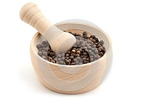 Black peppercorns in mortar