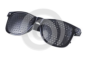 Black perforated glasses with holes isolated on white background. Medical spectacles. Perforated glasses.  Pinhole glasses.