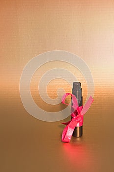 Black perfume bottle and pink ribbon