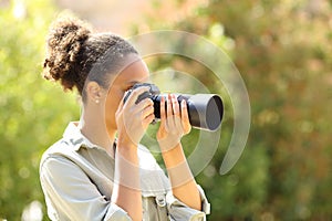 Black photographer taking photos in a garden