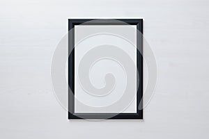 Black picture frame on white wall. Blank picture for art painting and photo hanging mockup