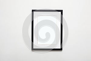 black picture frame on white wall. photoframe with passe-partout