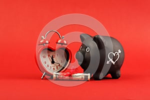 Black piggy bank with white heart and heart alarm clock and gift of money american hundred dollar bills with red ribb