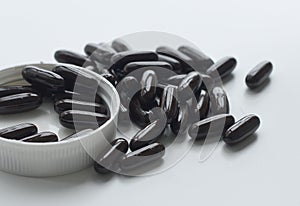 Black pill on white isolated with plastic caps and bottles
