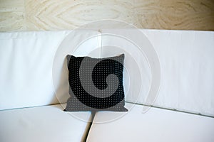 Black pillow on a sofa