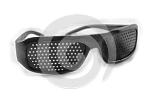 Black pinhole glasses on a light background