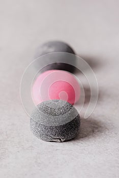 Black and Pink Traditional Japanese Rice Desserts on Light Gray Background Vertical Healthy Dessert