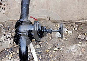 black pipe with a tap, processed bitumen polymer mixture. photo