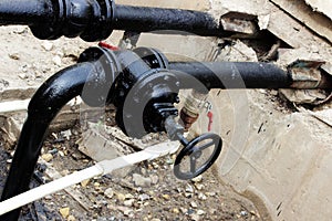 black pipe with a tap, processed bitumen polymer mixture. photo