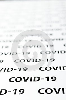 Black plain text on white paper about coronavirus outbreak. Covid-19