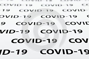 Black plain text on white paper about coronavirus outbreak. Covid-19