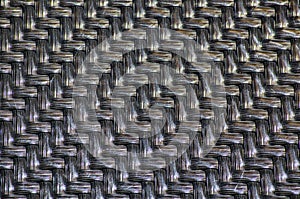 Black plastic basketwork pattern process of weaving or sewing pliable materials.