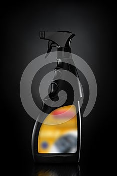 Black plastic bottle with liquid spray on black background