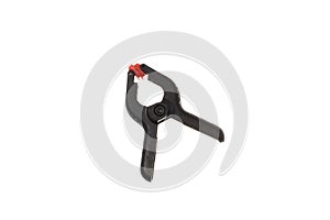 Black plastic clamp with red tips, isolated on white background