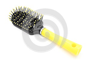 Black plastic comb with a yellow handle