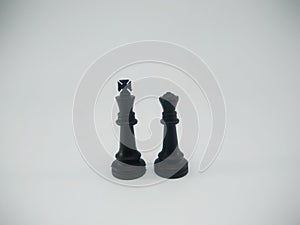 Black plastic couple of king and queen chess piece isolated on a white background