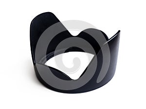 Black plastic four-petal lens hood for the camera lens