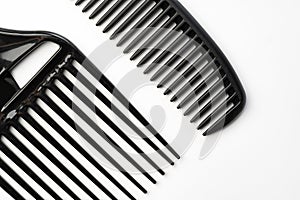 Black plastic hair comb isolated on white background