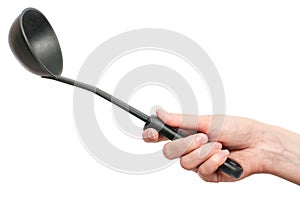 Black plastic kitchen ladle in hand isolated on white background