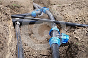 Black plastic pipes for irrigation in country