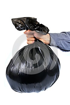 Black plastic trash bag held in hand