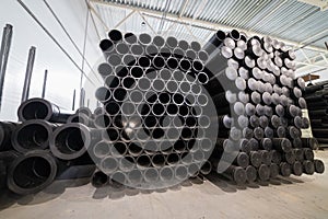 Black plastic tubes in the manufacturing storage