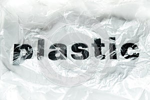 Black Plastic word on transparent white disposable plastic bag. Environment pollution problem concept image with copy space