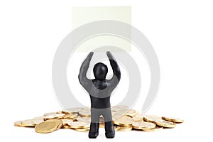 Black plasticine man with poster on his head isolated on a white background. Pile of money. Make money. Heap of coins