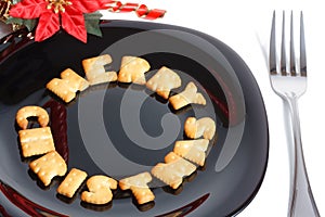 Black plate with cookies, fork and decoration