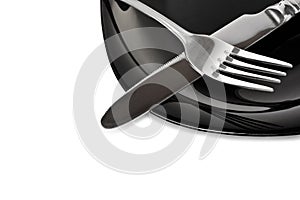 Black plate with fork and knife