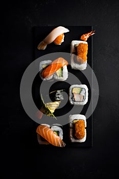 A black plate topped with sushi and shrimp. Generative AI image.