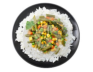 black plate with white rice, green peas, canned corn kernels, cut green beans isolated on white background. top view