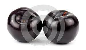 Black plums, isolated on white background