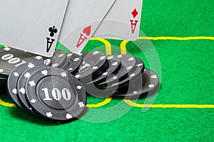 Black poker chips on which three aces fall