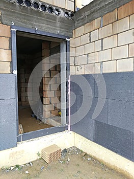 Black polystyrene foamboard on the house wall photo