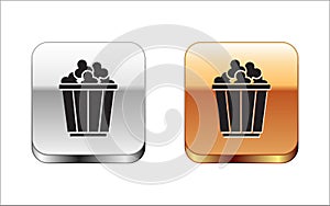 Black Popcorn in cardboard box icon isolated on white background. Popcorn bucket box. Silver and gold square buttons