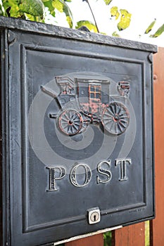 Black post box with vintage car carving in Ireland - Traditional communication channel