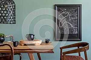 Black poster map in frame and kitchen accessories in stylish dining room.