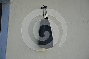 A black pouch hanging on the wall