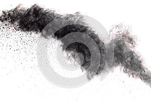 Black powder explosion. Closeup of black dust particles explode isolated on white background
