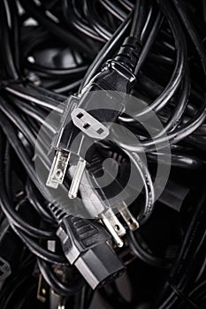 Black power cables cords in a pile