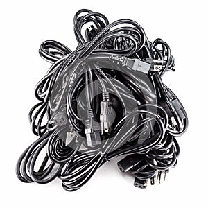 Black power cables cords pile on white background