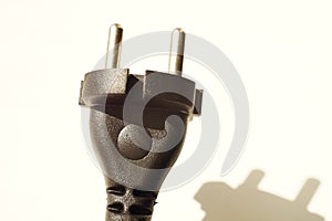 Black power plug on white background with shadow