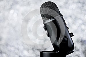 Black Profesional Microphone On Blurred Background photo