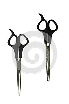 Black professional scissors for cutting regular and thinning. The working tools of a hairdresser