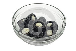 Black Prunes with cheese in a glass plate