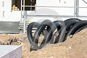 Black PVC flexible corrugated plastic insulation pipes tubing of electrical cables wire at undeground installation. New