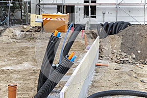 Black PVC flexible corrugated plastic insulation pipes tubing of electrical cables wire at undeground installation. New