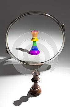 A black queen is looking in a mirror to see herself as queen covered with a rainbow flag.