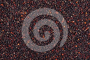 Black quinoa seeds background. Pile of raw kinwa. Top view.